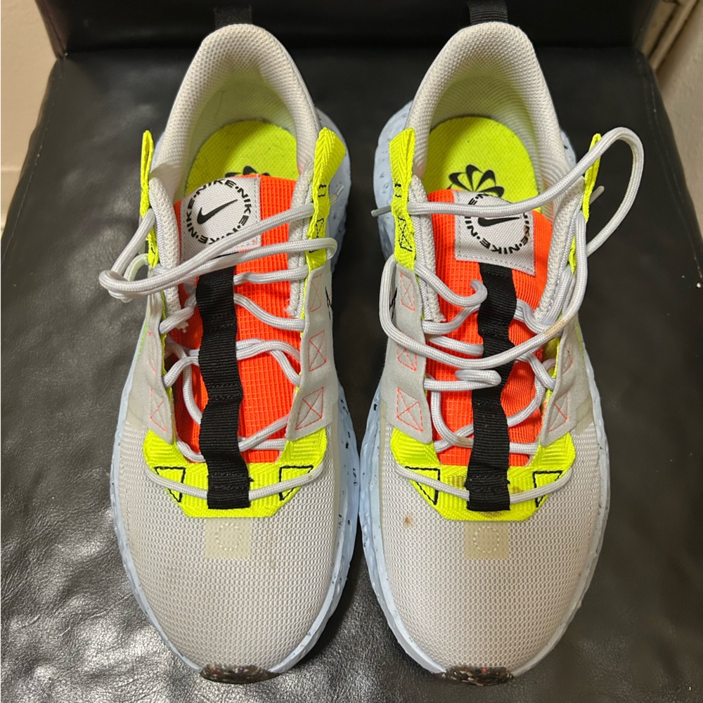 Orange neon and white Nike shoes